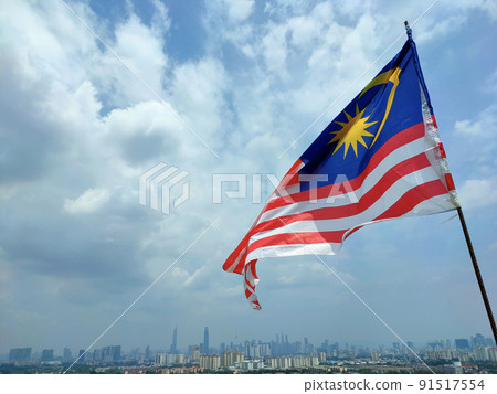 The Malaysian flag aka Jalur Gemilang is flown at a high place and against the backdrop of the Kuala Lumpur skyline The Malaysian flag aka Jalur Gemilang is flown at a high place and against the backdrop of the Kuala Lumpur skyline 91517554