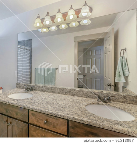 Square frame Interior of a bathroom with vanity sink with lights and mirror Square frame Interior of a bathroom with vanity sink with lights and mirror 91518097