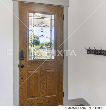 Square frame Interior of a front door with wall rail-mounted hanging hooks Square frame Interior of a front door with wall rail-mounted hanging hooks 91518098