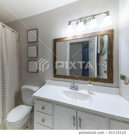 Square frame Bathroom interior with vanity sink, frames and closed shower curtain 91518120