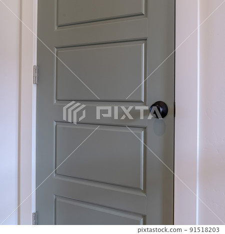 Square frame Home interior with close up view of the gray bedroom door with black door knob Square frame Home interior with close up view of the gray bedroom door with black door knob 91518203