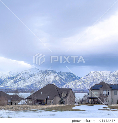 Square Lake front homes on a snowy neighborhood setting with Wasatch Mountains view 91518217