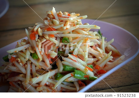 Selected focus on Papaya salad with shrimp, famous Thai food, Thai Salad, "Somtum" cuisine, green papaya, sweet, salty, tangy, and spicy flavor, recipe, street, Ingredients 91523238