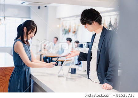 Young woman making a smartphone payment Young woman making a smartphone payment 91525735