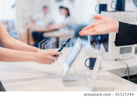 Young woman making a smartphone payment Young woman making a smartphone payment 91525744