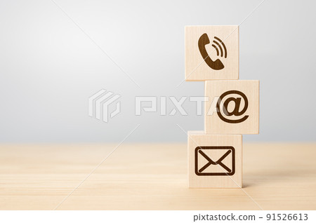 Contact us concept, Wood block symbol telephone, mail, and address on desk. Close-up Of Various Contact Options on wooden cubes. copy space. gray background Contact us concept, Wood block symbol telephone, mail, and address on desk. Close-up Of Various Contact Options on wooden cubes. copy space. gray background 91526613