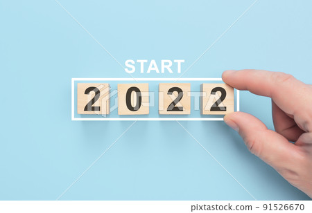 New start 2022 concept. Loading new year 2022 with hand putting wood cube in progress bar. Happy new year 2022. Start concept 91526670
