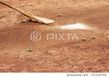 Ground maintenance using dragonfly rake to level the ground at a baseball field Ground maintenance using dragonfly rake to level the ground at a baseball field 91526748