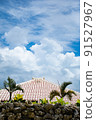 Stone wall, red roof tile and blue sky 91527967