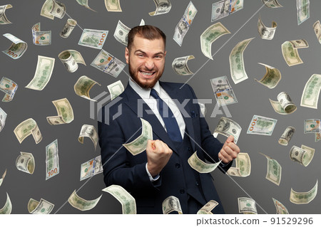 Businessman standing in the rain of money Businessman standing in the rain of money 91529296