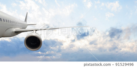 Flying airplane in blue sky clouds background 91529496