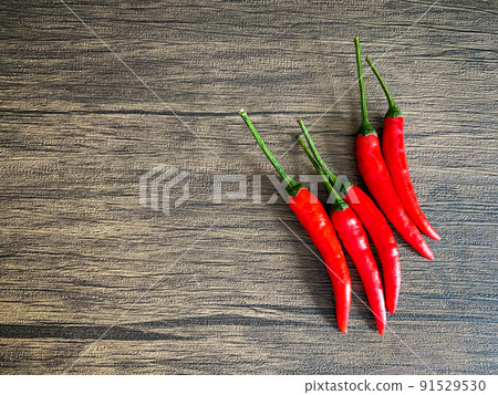 Fresh red chili and space for text on wooden background 91529530