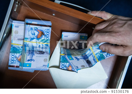 Thick wad of money cash on table Thick wad of money cash on table 91530176