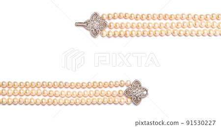 Triple strand freshwater pearl necklace with platinum hook set with diamonds on white background. Collection of luxury jewelry accessories. Studio shot Triple strand freshwater pearl necklace with platinum hook set with diamonds on white background. Collection of luxury jewelry accessories. Studio shot 91530227