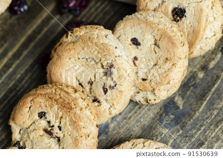 delicious dried cookies made of high-quality flour with dried red cranberries on the table 91530639