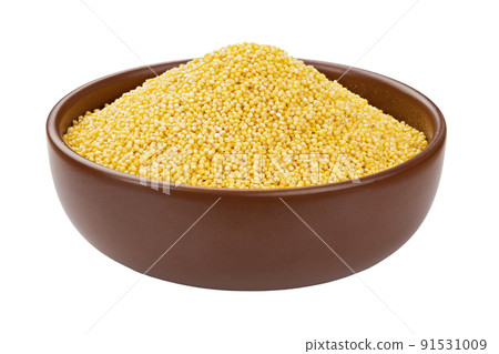 Dry millet groats in ceramic bowl, isolated on white background. Full depth of field. 91531009