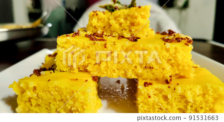 Gujarati Khaman Dhokla made using Chana Dal, served with Green chutney, selective focus 91531663