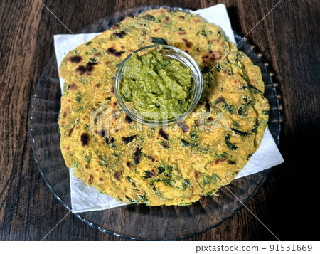 Palak paratha or Indian flat breads made from spinach and served with mango pickle and mint dip, Indian breakfast Palak paratha or Indian flat breads made from spinach and served with mango pickle and mint dip, Indian breakfast 91531669