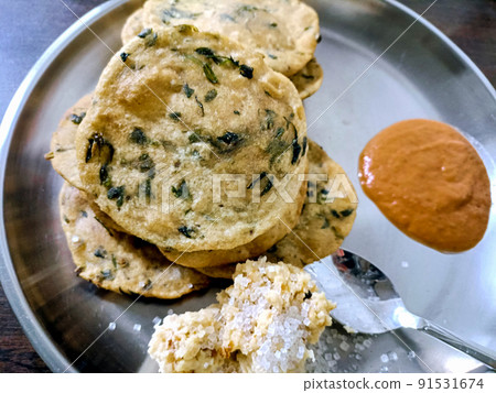 Poori an ideal indian breakfast served with tomato sauce 91531674