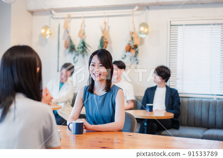 Two women having a conversation in a cafe Two women having a conversation in a cafe 91533789