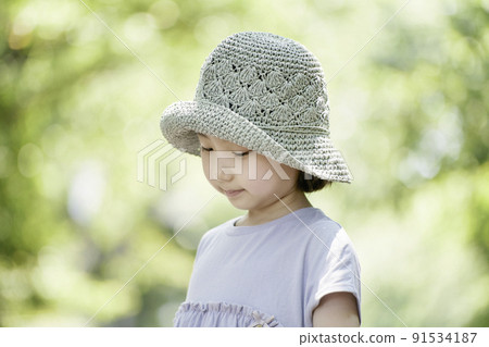 A girl wearing a straw hat A girl wearing a straw hat 91534187