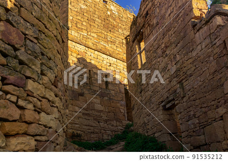 former street among the ruins in the abandoned mountain village of gamsutl in Dagestan 91535212
