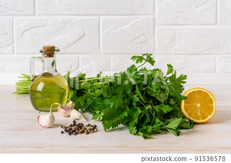 Green sauce ingredients. Salsa verde from fresh parsley, garlic cloves, olive oil and lemon juice. Green sauce ingredients. Salsa verde from fresh parsley, garlic cloves, olive oil and lemon juice. 91536578