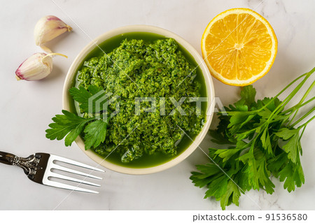 Fresh salsa verde in a bowl. Chimichurri dipping sauce from fresh parsley. Fresh salsa verde in a bowl. Chimichurri dipping sauce from fresh parsley. 91536580