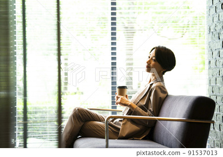 Business women office lobby relaxing break Business women office lobby relaxing break 91537013