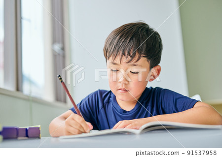 在筆記本上寫字的小學生 在筆記本上寫字的小學生 91537958