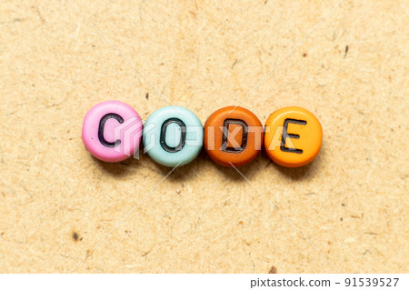 Round color bead with black letter in word code on wood background Round color bead with black letter in word code on wood background 91539527
