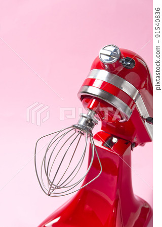 Red kitchen mixer on a pink background. Red kitchen mixer on a pink background. 91540836