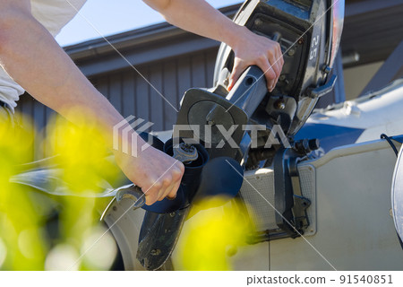 man changing propeller on outboard motor. Repairing outboard motor for boat, replacing screw. 91540851