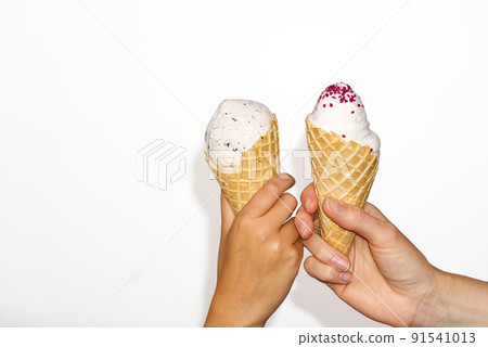mother and daughter Hands holds ice cream corn with milk ice cream. isolated on a white background. 91541013
