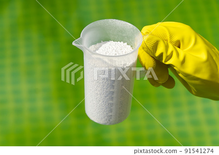 addition of chlorine powder for the pool to remove algae and disinfect water. inflatable swimming pool care concept. 91541274