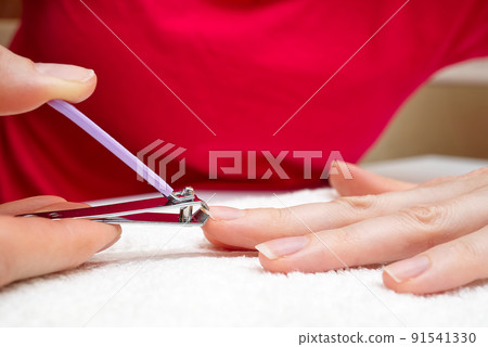 Woman cuts nails with nail cutter.Close-up Homemade manicure. Woman cuts nails with nail cutter.Close-up Homemade manicure. 91541330