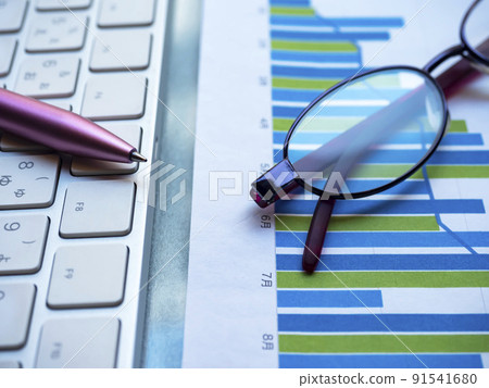 Business image of graphs, personal computers, glasses (female) Business image of graphs, personal computers, glasses (female) 91541680