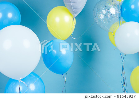 yellow, blue and white balloons on blue wall background copy space. Colorful balloon in room prepared for birthday party. copyspace helium balloons yellow, blue and white balloons on blue wall background copy space. Colorful balloon in room prepared for birthday party. copyspace helium balloons 91543927
