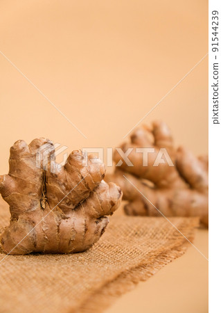 Fresh organic ginger rhizome root used in traditional medicines. Creative photo Earth tones natural background. 91544239