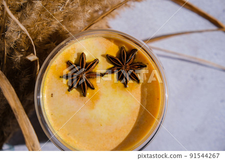 Pumpkin smoothie spiced latte. Anise stars. Autumn coffee with spicy pumpkin flavor seasonal hot drink. Fall Drinks for Halloween and Thanksgiving 91544267