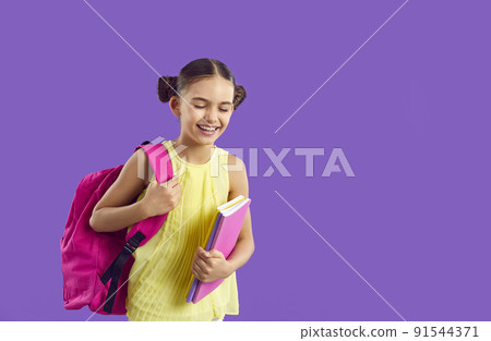 Cheerful preteen schoolgirl with backpack and notebooks laughing on purple background. Cheerful preteen schoolgirl with backpack and notebooks laughing on purple background. 91544371