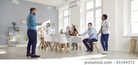 Corporate business manager talking to a team of people during a meeting in the office Corporate business manager talking to a team of people during a meeting in the office 91544372