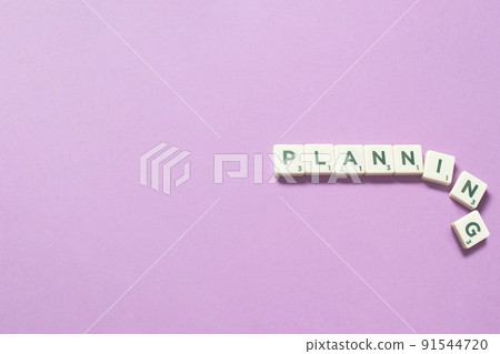 Planning formed of scrabble blocks on lilac background. Planning formed of scrabble blocks on lilac background. 91544720