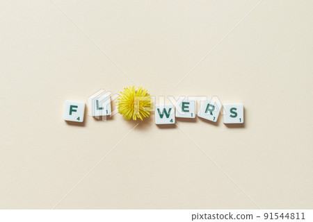 Scrabble tiles with dandelion on beige background. Scrabble tiles with dandelion on beige background. 91544811