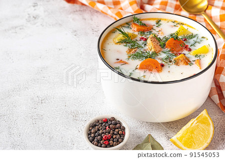 Lohikeitto, Finnish creamy salmon soup in a white bowl 91545053