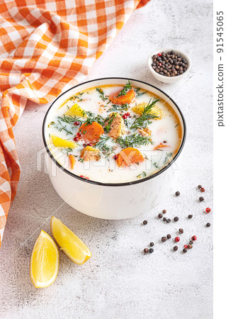 Lohikeitto, Finnish creamy salmon soup in a white bowl 91545065