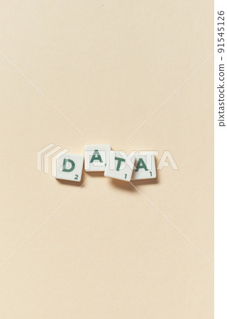 Data formed of scrabble blocks on beige background. Data formed of scrabble blocks on beige background. 91545126