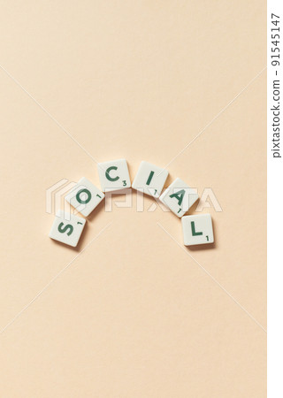 Social formed of scrabble tiles on beige background. 91545147