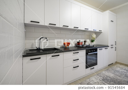 Trendy white modern kitchen interior with minimalistic furniture 91545684