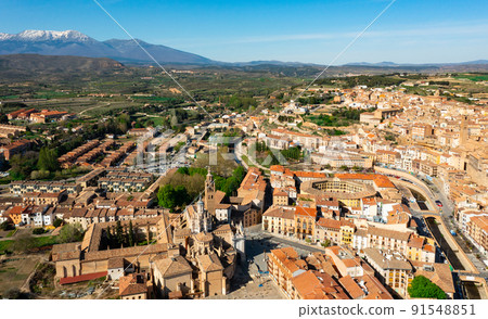Aerial view of Tarazona cityscape with snow-capped Moncayo in background 91548851